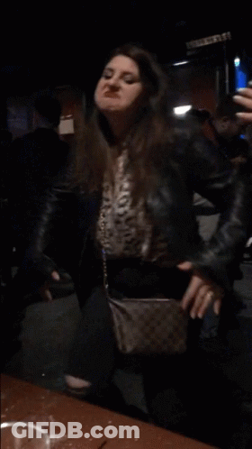 Woman In Leather Jacket Taking Mirror Selfie GIF