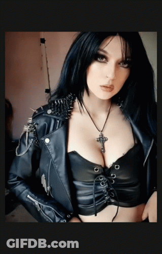 Woman In Leather Jacket With Spikes And Cross Necklace GIF