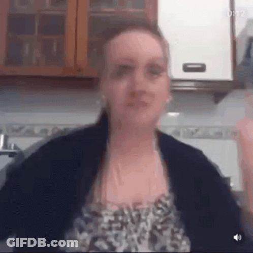 Woman In Leopard Print Arms Outstretched In Kitchen GIF