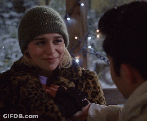 Woman In Leopard Print Coat And Beanie Holding Man's Hand GIF