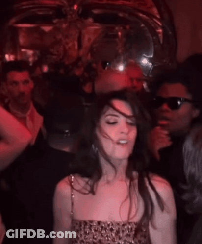 Woman In Leopard Print Dress Dancing In Crowd GIF
