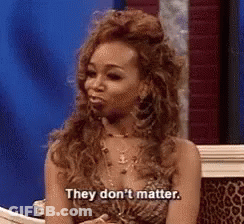 Woman In Leopard Print Dress Sitting On Couch Saying They Don't Matter GIF
