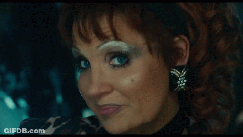 Woman In Leopard Print Shirt And Earrings GIF