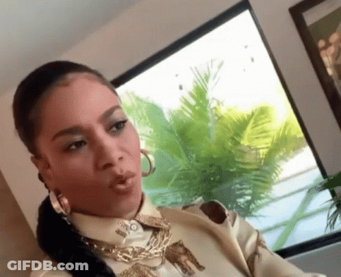 Woman In Leopard Print Shirt And Hoop Earrings GIF