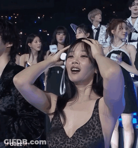 Woman In Leopard Print Top Holding Head GIF