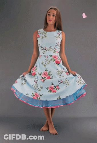 Woman In Light Blue Floral Dress And Pink Rose GIF