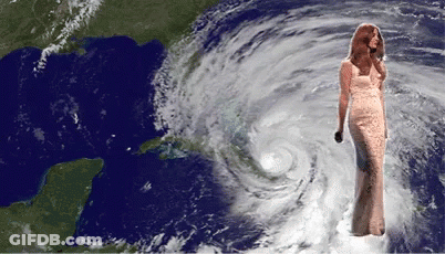 Woman In Long Dress In Front Of Hurricane GIF