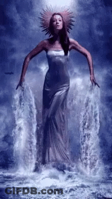 Woman In Long Dress Standing In Water GIF