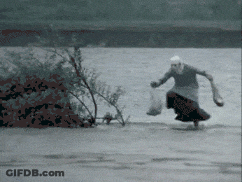 Woman In Long Skirt Running Across River GIF