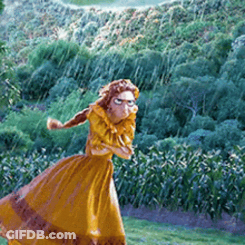 Woman In Long Yellow Dress Standing In Field GIF