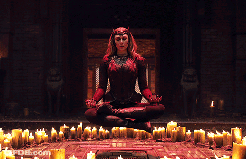 Woman In Lotus Position In Front Of Candles GIF