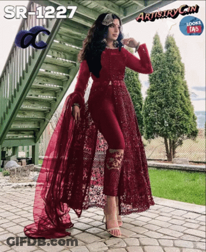 Woman In Maroon Dress Standing In Front Of Staircase GIF
