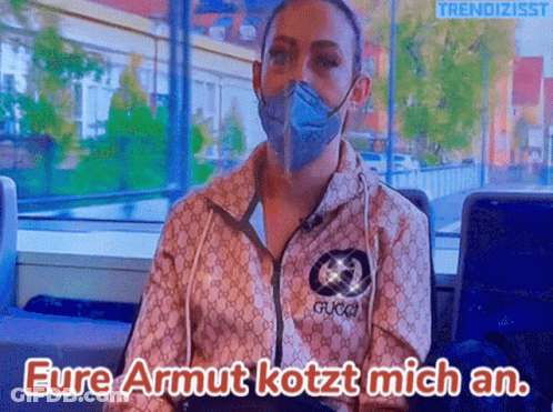 Woman In Mask And Gucci Jacket Says Eure Armut Kotzt Mich An GIF