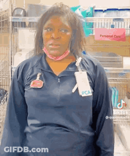 Woman In Mask And PCA Name Tag GIF