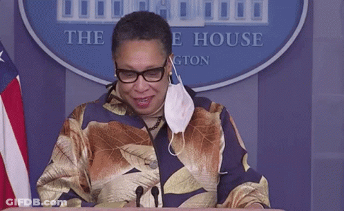 Woman In Mask At Podium Before White House Sign GIF