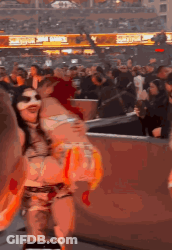 Woman In Mask Dancing At Stadium Smackdown Sign GIF