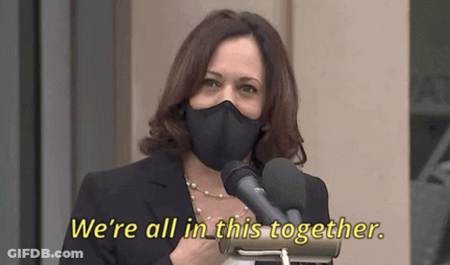 Woman In Mask Speaking Into Microphone Saying We're All In This Together GIF