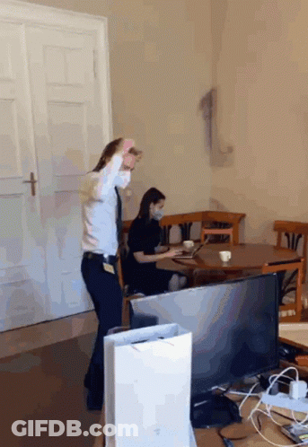 Woman In Mask Watching Man Dance GIF