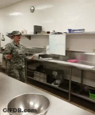Woman In Military Uniform In Kitchen GIF