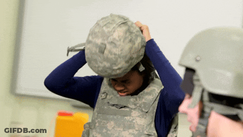 Woman In Military Uniform Putting On Bulletproof Vest GIF