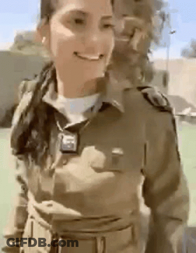 Woman In Military Uniform Smiling In Field GIF