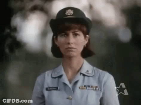 Woman In Military Uniform Standing In Front Of Tree GIF