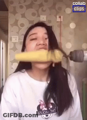 Woman In Minnie Mouse Shirt Biting Banana GIF