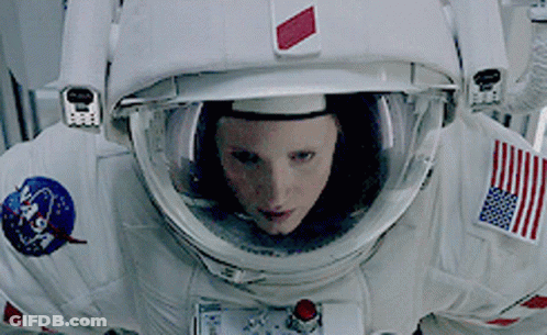 Woman In NASA Space Suit Looking At Camera GIF