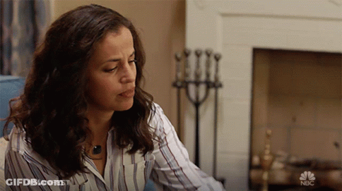 Woman In NBC Shirt By Fireplace GIF