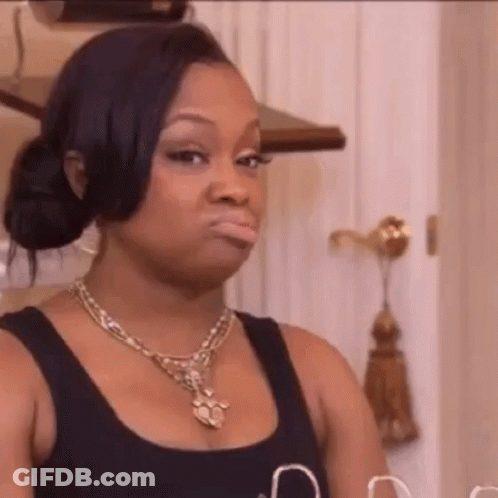 Woman In Necklace And Black Tank Top Making A Face GIF
