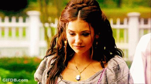 Woman In Necklace And Earrings At White Picket Fence GIF