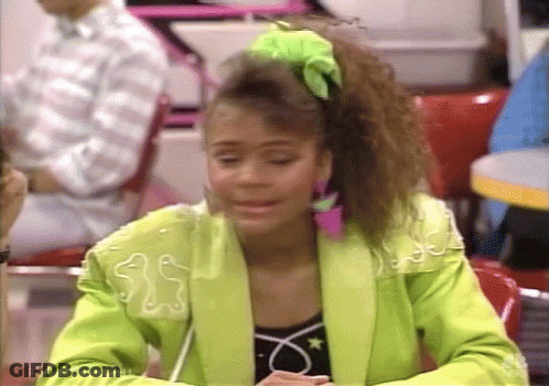 Woman In Neon Green Jacket Sitting At Restaurant Table GIF