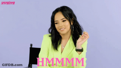 Woman In Neon Green Jacket Thinking Hmmmm GIF
