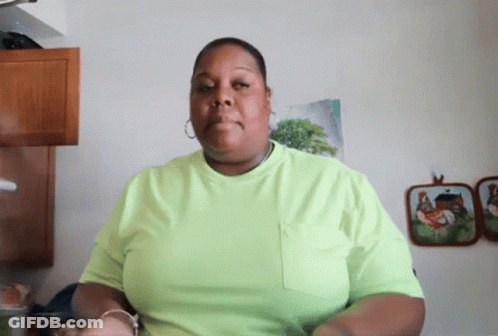 Woman In Neon Green Shirt In Front Of Chicken Pictures Wall GIF