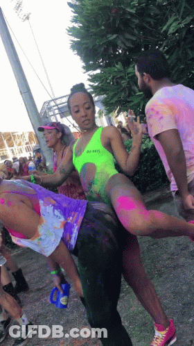 Woman In Neon Green Swimsuit Lifted By Man GIF