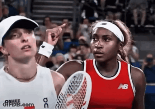 Woman In New Balance Shirt Points At Usopen.org Sign GIF