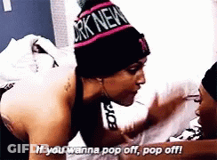 Woman In New York Beanie Talking To Another GIF