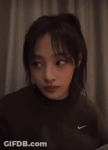 Woman In Nike Sweatshirt Looking At Camera GIF