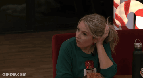 Woman In Nutcracker Sweater Holding Head GIF