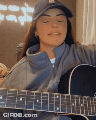 Woman In NY Yankees Hat Playing Acoustic Guitar GIF