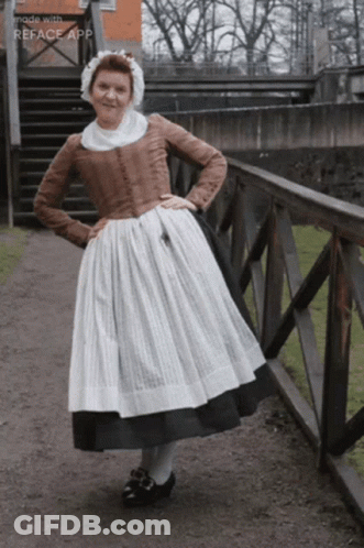 Woman In Old Fashioned Dress Next To Railing GIF