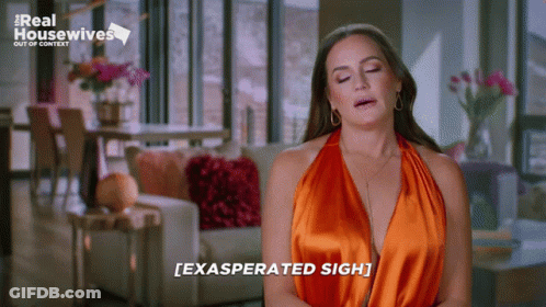 Woman In Orange Dress Exasperated Sigh GIF