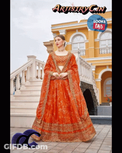 Woman In Orange Dress In Front Of Building Artistry Gin Looks Tab GIF