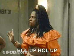 Woman In Orange Dress Talking At Door GIF