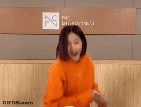 Woman In Orange Hoodie Dancing GIF