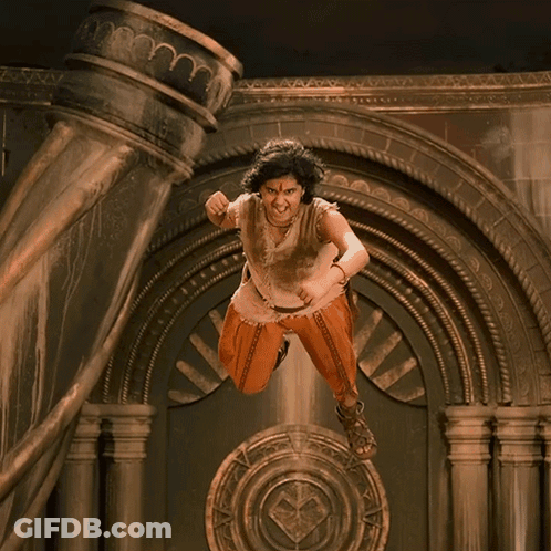 Woman In Orange Pants Standing In Front Of Horn GIF