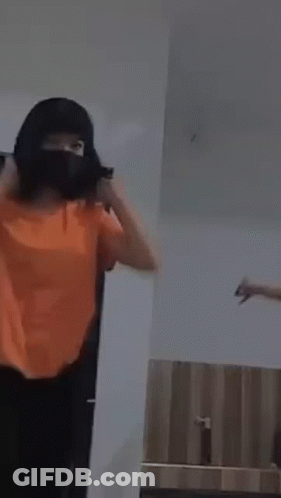 Woman In Orange Shirt Dancing With Another GIF