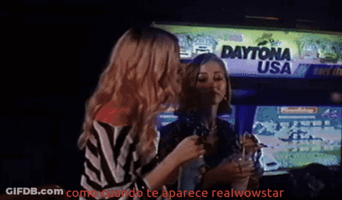 Woman In Orange Shirt Pouring Drink Into Glass GIF