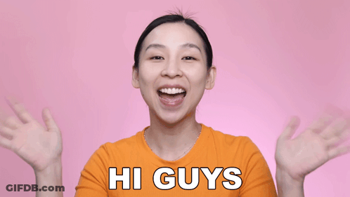 Woman In Orange Shirt Saying Hi GIF