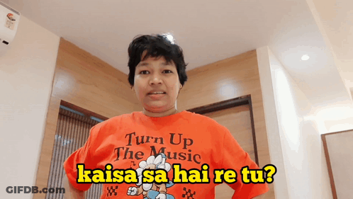 Woman In Orange Shirt Saying Turn Up The Music GIF